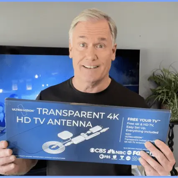 Man holding the Savvy Ultra-Vizion 2800 transparent 4K HD TV antenna box
